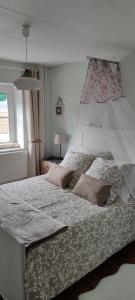 a bedroom with a large white bed with two pillows at La maison de Céline in Arry +42 photos