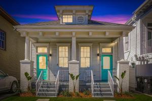 a house with a green door and stairs at Private 2BR Condo in Uptown by Hosteeva in New Orleans