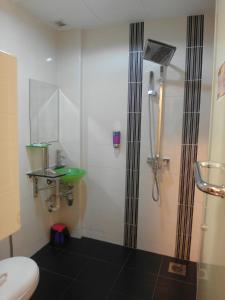 a bathroom with a shower and a sink and a toilet at Bahagia Hotel Langkawi in Kuah