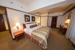 a hotel room with a large bed and a desk at Alyeska Resort in Girdwood