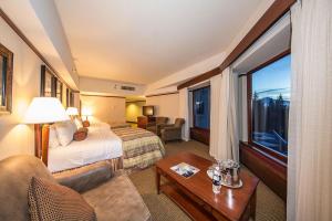 a hotel room with a bed and a window at Alyeska Resort in Girdwood