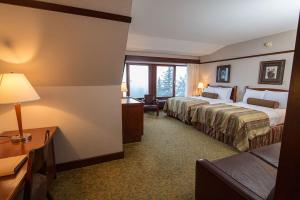 a hotel room with a bed and a desk at Alyeska Resort in Girdwood
