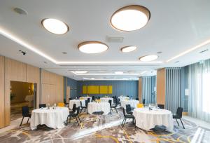 a conference room with white tables and black chairs at InterContinental Marseille - Hotel Dieu, an IHG Hotel in Marseille