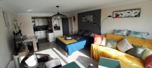 a living room with a couch and a table at Studio face à la mer in Concarneau