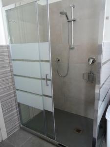 a shower with a glass door in a bathroom at Crêuza da me ღ in Genova