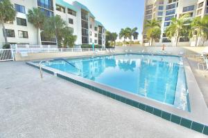a large swimming pool in front of a building at The Wave Song in Fort Pierce
