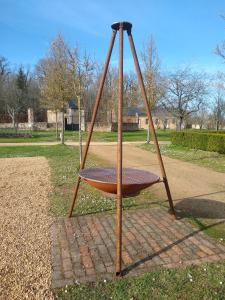 a swing set in a park with at Domaine de la Vaudourière in Lunay
