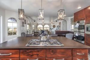 a kitchen with a stove top in a room at Luxury Estate in Prime Location w Panoramic views of Lake Havasu in Lake Havasu City