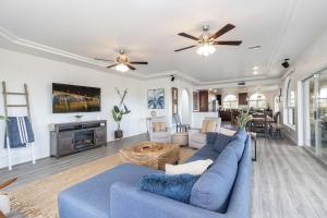 a living room with a blue couch and a fireplace at Luxury Estate in Prime Location w Panoramic views of Lake Havasu in Lake Havasu City