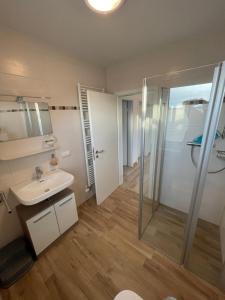 a bathroom with a shower and a sink at Wangerkajüte in Wangerland