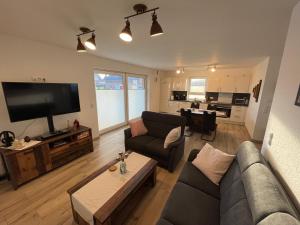 a living room with a couch and a tv at Wangerkajüte in Wangerland