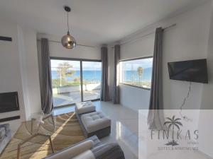 a living room with a view of the ocean at Finikas Suites & Apartments Airport By Airstay in Artemida
