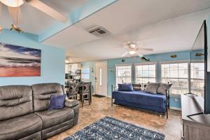 a living room with a couch and a bed at Surfside Beach Gem with Deck - 1 Block to Shore! in Freeport