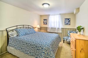 a bedroom with a bed and a chair and a window at Updated Home in the Heart of Saratoga Springs in Saratoga Springs