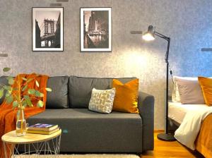 Студия NEW YORK в самом центре города في ألماتي: غرفة معيشة مع أريكة ومصباح
