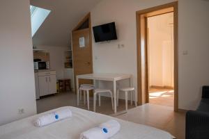 a room with a kitchen and a table with two towels at Beach Apartments Marijana in Vodice