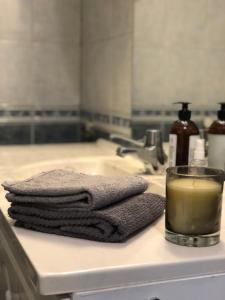 a towel and a glass of candle on a bathroom sink at Fagre Stryn Feriehus in Stryn