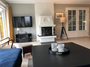 a living room with a table and a fireplace at Fagre Stryn Feriehus in Stryn