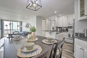 a kitchen and dining room with a table and chairs at Heavenly Oceanfront Condo with Amenities Galore in Oceanside