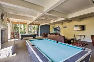 a large living room with a pool table at Charming Oceanside Condo with Beach and Pool Access! in Oceanside