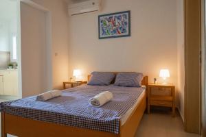 a bedroom with a bed with two towels on it at Beach Apartments Marijana in Vodice