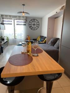 a table with two wine glasses on it in a living room at Studio Disneyland Paris Holidays in Montévrain