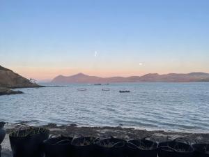 a large body of water with boats in it at Bryn Noddfa in Morfa Nefyn