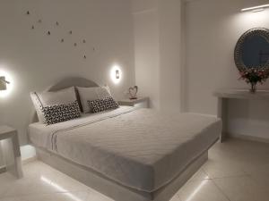 a bedroom with a bed and a lamp at Kiklamino Studios & Apartments in Oia