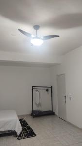 a white room with a ceiling fan and a bed at Catumbi Studio 8 in Sao Paulo