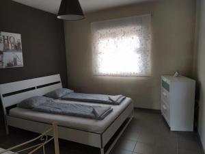 a small bedroom with a bed and a window at OceanBlue Modern king size 1 Bedroom Apartment with Seaview and Terrace in Chayofa