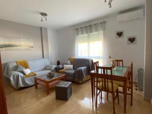a living room with a couch and a table at Apartamento Turistico San Cristobal in Plasencia