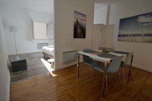 a room with a table and chairs and a bedroom at Duplex with a view in Montpellier