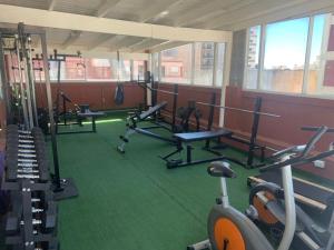 a gym with several treadmills and machines at Bianca's Apartament Santa Teresita in Santa Teresita