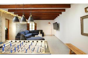 a living room with a ping pong game on a table at Jaume Ramona in Pollença
