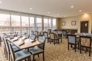 a restaurant with tables and chairs and large windows at Wyndham Avon in Avon Center