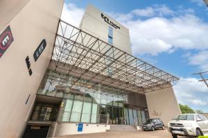 un edificio con un coche aparcado delante en Tri Hotel Executive Lajeado, en Lajeado