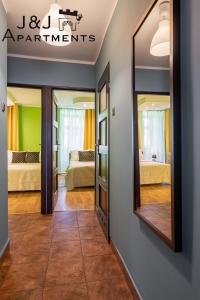 a room with two beds and a mirror at J&J Apartments, Szczytna 1, Apartament 9 in Toruń