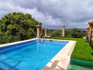 a swimming pool in the yard of a house at Casa Rural Bellavista Ronda in Ronda