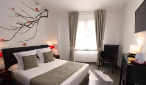a hotel room with a bed and a window at Le Petit Boutique Hotel in Santander