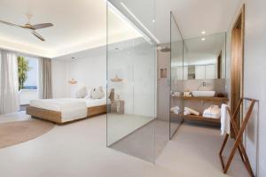a bedroom with a bed and a glass shower at Maya Beach Resort in Massa Lubrense