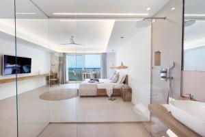 a bathroom with a bed and a glass shower at Maya Beach Resort in Massa Lubrense