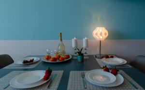 a dining room table with plates and fruit on it at Holiday Home Slavia New 810 z widokiem na morze in Międzyzdroje