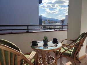 a table and chairs on a balcony with a view at Antoni Apartment in Skopje
