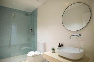 a bathroom with a sink and a shower with a mirror at Casa do Gadanha in Estremoz +65 photos