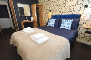 a bedroom with a bed with two towels on it at The Blue Bell Inn in Kettlewell