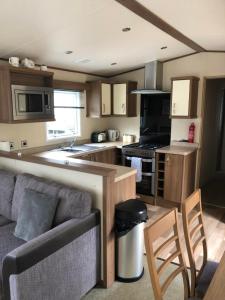 a kitchen with a couch and a stove top oven at River View in Dunoon