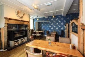 a dining room with a table and a fireplace at The Blue Bell Inn in Kettlewell