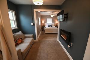 a living room with a couch and a fireplace at The Lakehouse Inn Geneva in Geneva-on-the-Lake