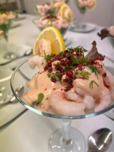 a plate of food with shrimp and a lemon on a table at Bryn Noddfa in Morfa Nefyn