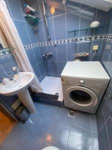 a bathroom with a washing machine and a sink at Beachfront two bedroom apartment Angelina in Đenovići